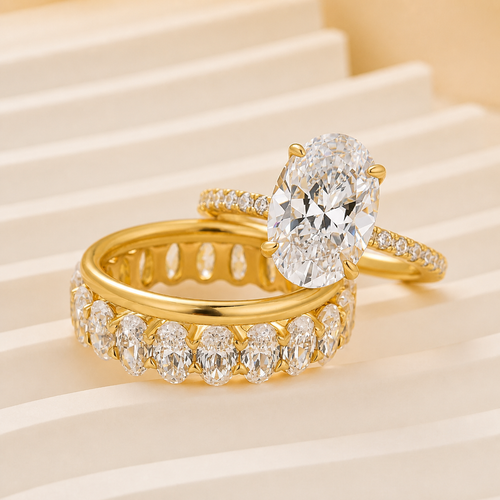 Elara three-piece oval wedding ring set in yellow gold – studio view