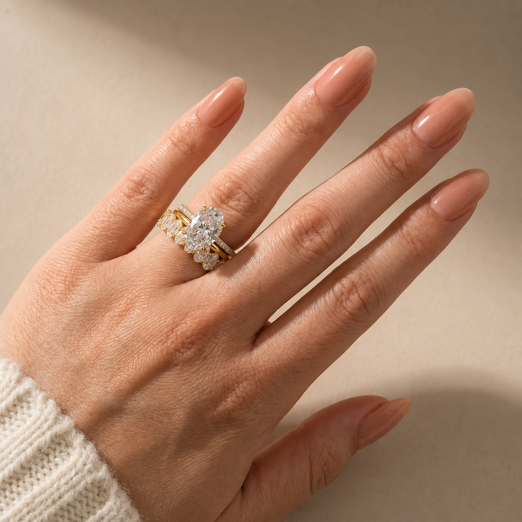 Elara three-piece oval wedding ring set in yellow gold – worn view