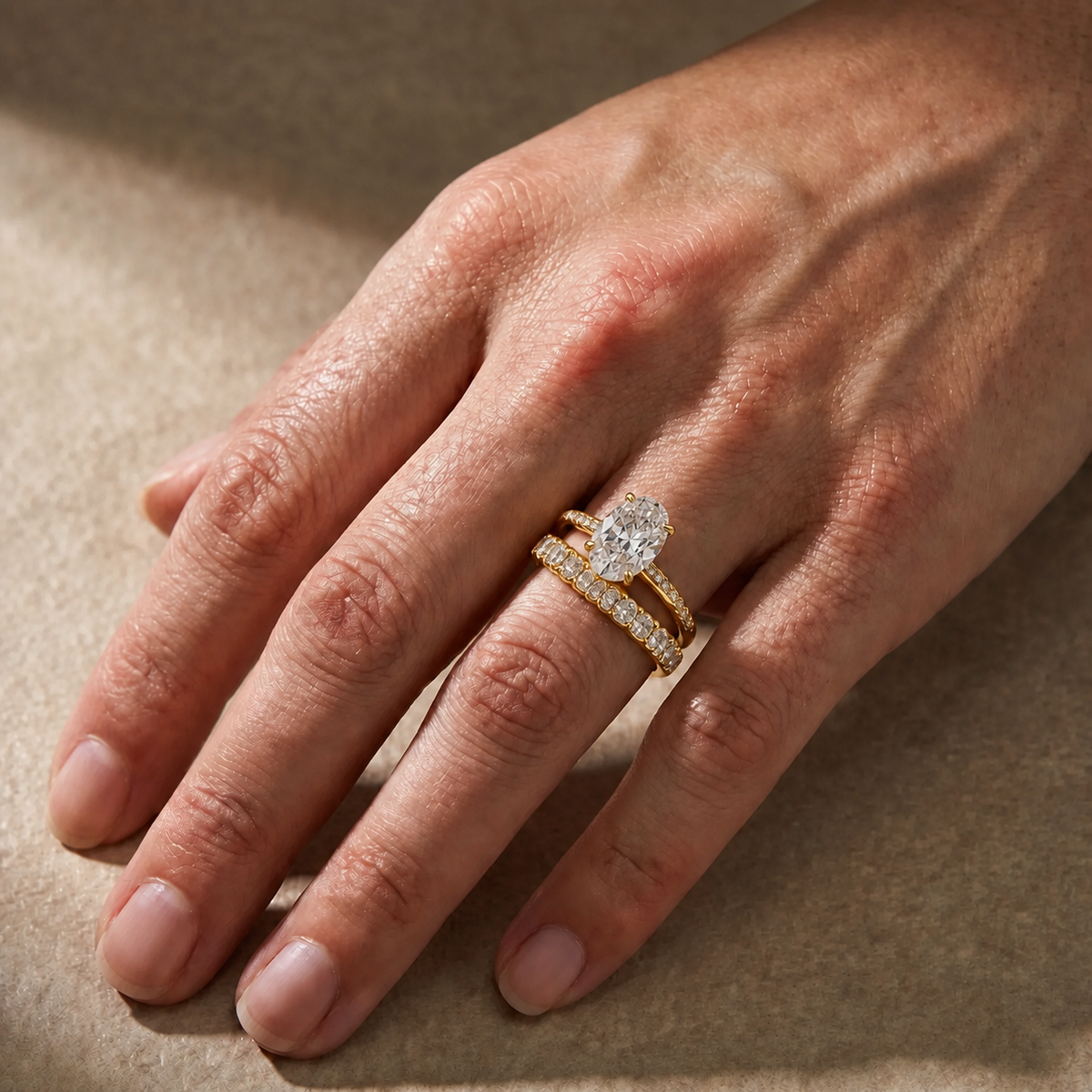 Elara three-piece oval wedding ring set in yellow gold – alternate worn view