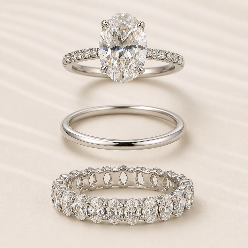Elara three-piece ring set shown separately: oval engagement ring, polished band, and oval eternity band